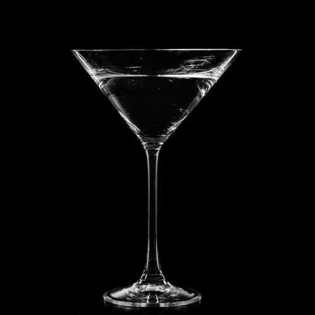 Martini in a cocktail glass isolated on black backgroundの写真素材