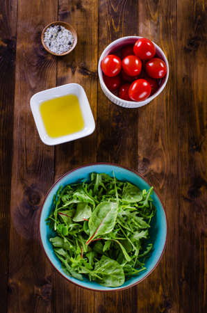 simple fresh salad ingredients on dark wooden backroundの写真素材