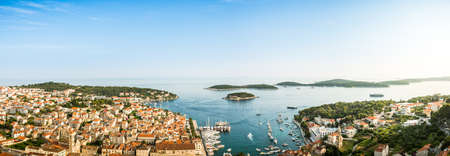 Wonderful romantic summer afternoon landscape panorama coastline Adriatic sea. A narrow mountain road above the cliffs along the coast. The clear azure water in the bay. Hvar island. Croatia. Europe.の写真素材