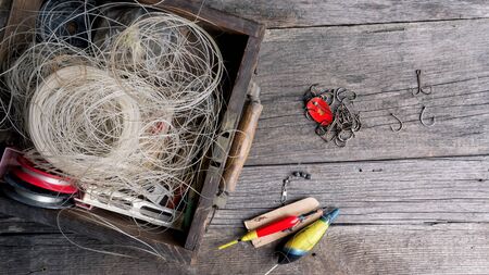 Fishing tools and accessories on the old wooden table.の写真素材