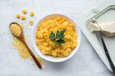 Corn porridge with butter on concrete background. Top viewの写真素材