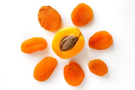 Creative  isolated pattern made of dry apricots and one fresh sliced fruit.の写真素材