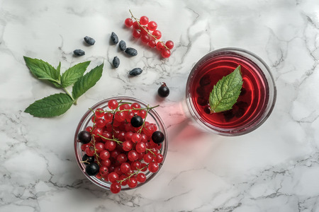 Fruit drink with fresh berries and mint leaves on table. Top view.
