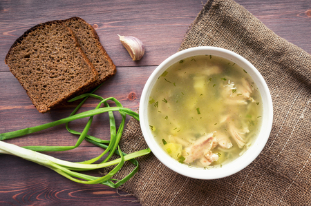 Chicken soup with noodles. Rustic photo. Top viewの写真素材