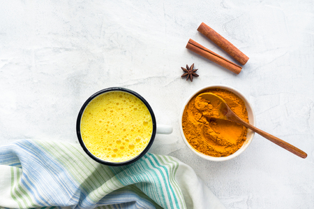 Turmeric latte, Cooking Golden Milk On Kitchen. Hot healthy drink. Concrete background. Top view.の写真素材