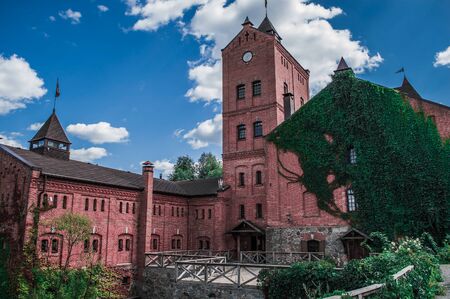 Landscape of the old red brick castle with a tower.