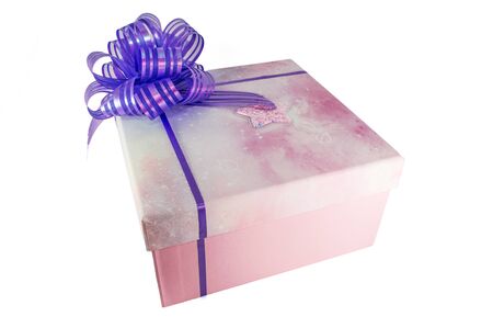 Pink box with a big bow isolated on white backghround. Closeup photo of Christmas or birthday presentの写真素材