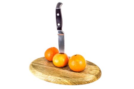Orange mandarins or tangerines on cutting board isolated on white background. Closeup photos of...