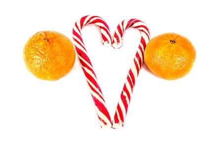 Orange mandarins or tangerines with christmas baubles isolated on white background. Closeup photos of fresh citrus fruit.の写真素材