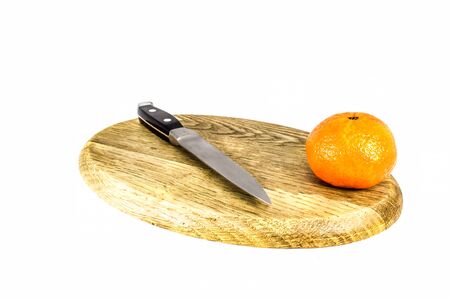 Orange mandarins or tangerines on cutting board isolated on white background. Closeup photos of fresh citrus fruit.の写真素材