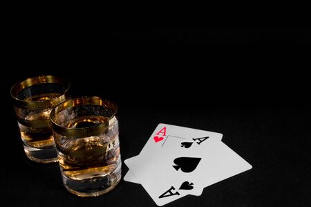 Short Glass of dark red whiskey, brandy or 
bourbon isolated on black background. Closeup photo of alcoholの写真素材