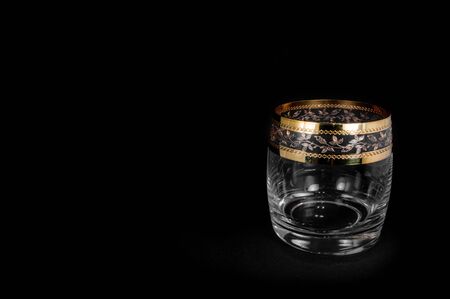 Empty glass for whiskey, brandy or 
bourbon isolated on black background. Closeup photo of  tumblerの写真素材