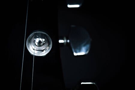 Red electric guitar closeup isolated on black backgroundの写真素材