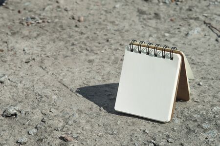Notebook with white paper on the ground. Closeup photo of notebook. Mock-up for recordsの写真素材
