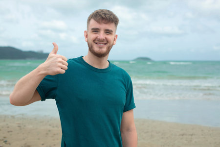 Happy guy, young handsome man is enjoying summer vacation at sea, beach in tropical exotic country,...