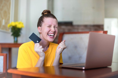 Portrait of happy excited amazed girl, shocked young successful joyful woman paying, holding credit...