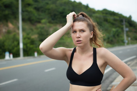 Portrait of unhappy tired exhausted girl, young woman runner with headache is running, jogging...