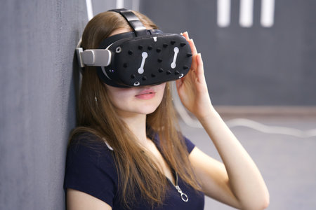 Portrait of happy young beautiful woman, young girl using, wearing a modern device virtual reality...