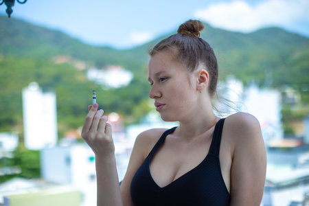 Stop smoking, quit or no smoking cigarettes. Woman holding broken cigarette in hands. Woman refusing cigarettes. Quit bad habit.の写真素材