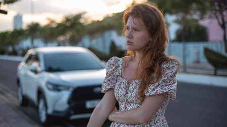 girl's car broke down on the road, sad, looking for helpの写真素材