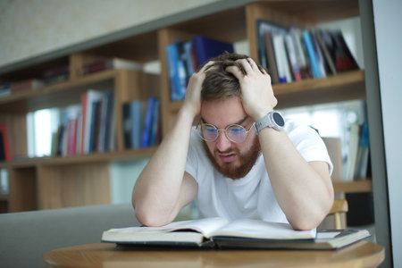 Portrait of tired overworked guy, exhausted young man in glasses college or university student is...