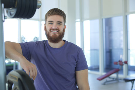 Bearded young man training in the gym and looking at cameraの写真素材
