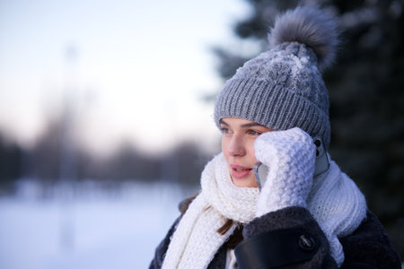 Portrait of beautiful girl young frozen pretty woman standing walking in winter snowy park at cold...