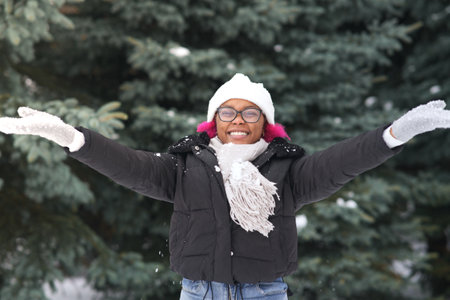 Happy young woman play with snow at winter cold dayの写真素材