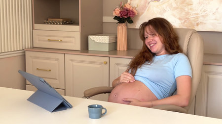 Young happy pregnant woman office employee, freelancer worker working at home