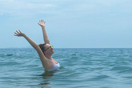 portrait of a beautiful young woman on vacation enjoying a holiday at sea, concept positive,...