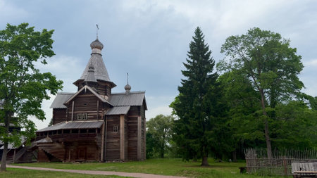 Beautiful Traditional Wooden Church Surrounded by Lush Nature and Scenic Landscapesの写真素材