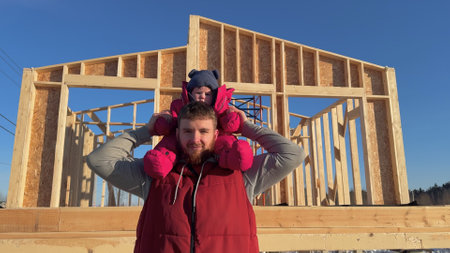 Happy young woman with her kid on hands celebrating buying a new house, moving to homeの写真素材
