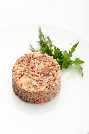 Buckwheat with mushrooms and parsley on a white backgroundの写真素材