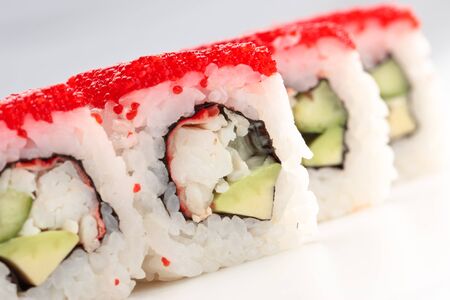 California rolls on a white background with red caviarの写真素材
