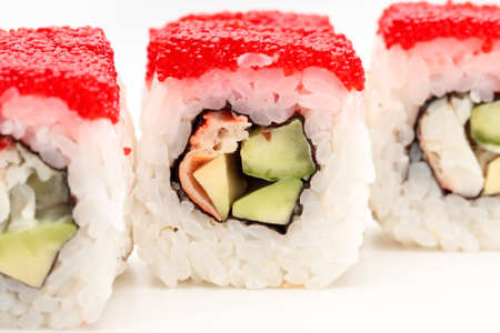 California rolls on a white background with red caviarの写真素材