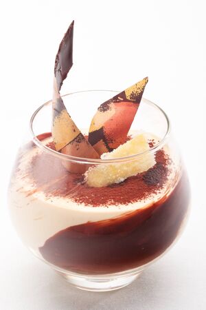 Caramel cream with ginger snaps decorated with chocolate on a white backgroundの写真素材