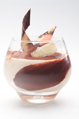 Caramel cream with ginger snaps decorated with chocolate on a white backgroundの写真素材