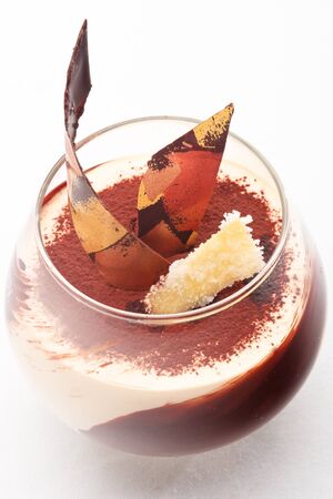 Caramel cream with ginger snaps decorated with chocolate on a white backgroundの写真素材