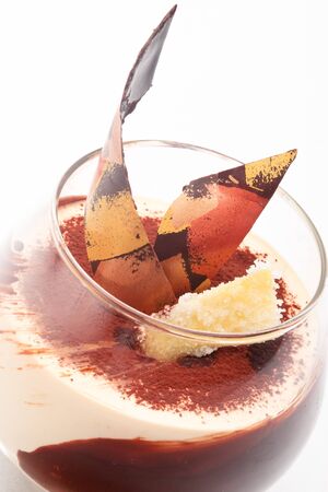Caramel cream with ginger snaps decorated with chocolate on a white backgroundの写真素材