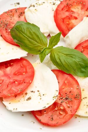 Close up of Caprese salad - tomatoes, mozzarella and basilの写真素材
