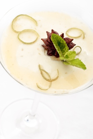Close-up of lime and pear mousse decorated with anise and mint on a white backgroundの写真素材
