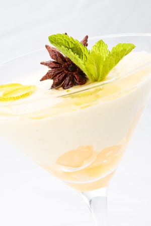 Close-up of lime and pear mousse decorated with anise and mint on a white backgroundの写真素材