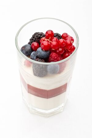 Panna cotta with Fresh forest berries in a glass on a white background isolated, Italian dessertの写真素材