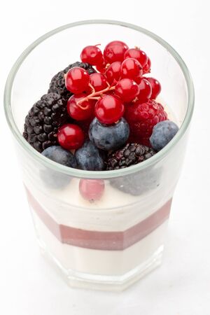 Panna cotta with Fresh forest berries in a glass on a white background isolated, Italian dessertの写真素材