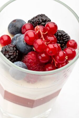 Panna cotta with Fresh forest berries in a glass on a white background isolated, Italian dessertの写真素材