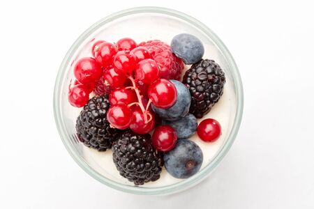 Panna cotta with Fresh forest berries in a glass on a white background isolated, Italian dessertの写真素材