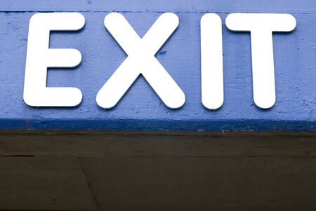 Closeup of a blue and white exit signの写真素材