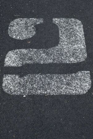 Number two written in chalk on black asphaltの写真素材
