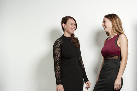 Happy young girls posing on a white background in a studio.の写真素材