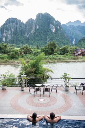 View of the Karst mountains from a hotel on the riverside in Vang Vieng. Vang Vieng is a riverside...